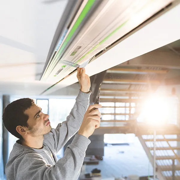 Painter Stelzle checks that the sawing work on the ceiling has been carried out correctly