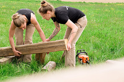 Two carpenters examining wood for the next project