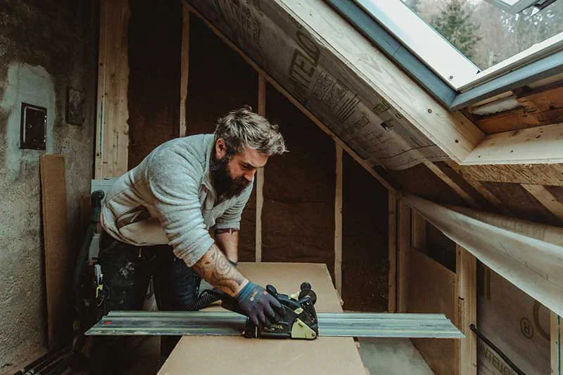 The Festool PLANEX long-reach sander in operation on a loam wall