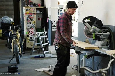 Maker Laura Kampf working in her workshop using a compound mitre saw by Festool.