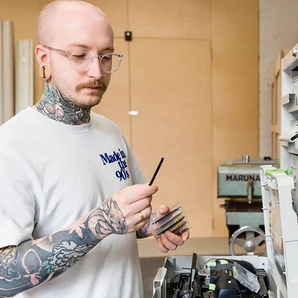 Master carpenter and product designer Jonas Winkler selecting the right jigsaw blade